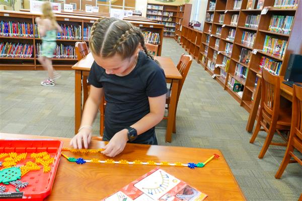 student with colorful blocks